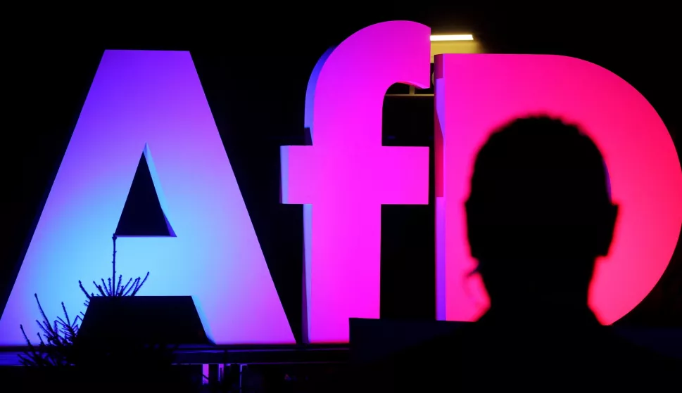 epa11919520 An illuminated AFD logo is seen at the Alternative for Germany (AfD) election event in Berlin, Germany, 23 February 2025. EPA/FILIP SINGER