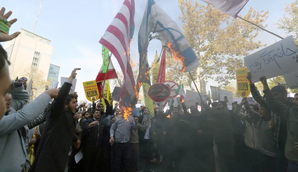 epa07140616 Iranians burn USA and Israel flags during an anti-US demonstration marking the 39th anniversary of US Embassy takeover, in front of the former US embassy in Tehran, Iran, 04 November 2018. Media reported that Thousands of protesters chanting 'Death to America' gathered at the former US embassy in Tehran to mark the 39th anniversary of the start of the Iran hostage crisis. Iranian students occupied the embassy on 04 November 1979 after the USA granted permission to the late Iranian Shah to be hospitalized in the States. Over 50 US diplomats and guards were held hostage by students for 444 days. US President Donald J. Trump's administration announced on 02 November 2018, that it will reimpose sanctions against Iran that had been waived under the 2015 Iran nuclear deal (the Joint Comprehensive Plan of Action, JCPOA). The US sanctions will take effect on 05 November 2018, covering Iran's shipping, financial and energy sectors. In 2015, five nations, including the United States, worked out a deal with the Middle Eastern country that withdrew the sanctions, one of former US President Barack Obama's biggest diplomatic achievements. EPA/ABEDIN TAHERKENAREH