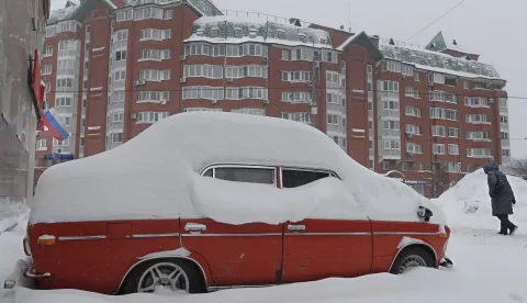 epa11027012 An old car of Lada brand is covered in snow after a heavy snowfall in Moscow, Russia, 13 December 2023. Many people in Russia do not use their old cars during winter because snow and cold weather increase the chance of breakdown. Old cars are left until spring in municipal parking of residential areas, where its turn into snowdrifts. These cars are usually jokingly called Snowdrops (Galanthus, one of the first spring flowers, usually appearing from under the snow). The temperatures reached about -12 degrees Celsius in Moscow. EPA/MAXIM SHIPENKOV