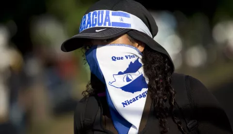 epa06820013 A young girl with her face covered participates in a sit-in at an event held to commemorate the start of the anti-government protests in Nicaragua, which have been sustained for two months, and have resulted in the deaths of at least 180 people, in Managua, Nicaragua, 18 June 2018. Dozens of people returned to peacefully protest in the same place where two months ago a sit-in was held to reject reforms to Social Security in Nicaragua, and became the catalyst for the anti-government protests and political violence in the Central American country. EPA/JORGE TORRES