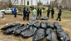epa09887828 Bodies are exhumed and removed from the mass grave near the St. Andrew and All Saints Church in Bucha city of Kyiv (Kiev) area, Ukraine, 13 April 2022. Forensic investigators began exhuming a mass grave in Bucha containing more than 410 bodies of civilians, according to Ukrainian officials. The UN Human Rights Council has decided to launch an investigation into the violations committed after Russia's full-scale invasion of Ukraine, the Ukrainian Parliament reported. Russian troops entered Ukraine on 24 February resulting in fighting and destruction in the country and triggering a series of severe economic sanctions on Russia by Western countries. EPA/OLEG PETRASYUK