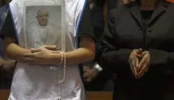 epa12045370 A person holds a portrait of Pope Francis during a mass at the Metropolitan Cathedral in Rio de Janeiro, Brazil, 21 April 2025. Pope Francis died on 21 April 2025 at the age of 88, according to the Holy See. Born Jorge Mario Bergoglio in Buenos Aires, Argentina, on 17 December 1936, he was appointed leader of the Catholic Church on 13 March 2013, succeeding Pontiff Emeritus Benedict XVI. EPA/ANTONIO LACERDA