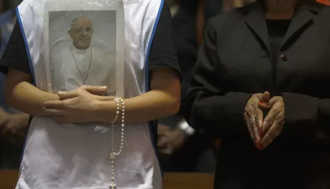 epa12045370 A person holds a portrait of Pope Francis during a mass at the Metropolitan Cathedral in Rio de Janeiro, Brazil, 21 April 2025. Pope Francis died on 21 April 2025 at the age of 88, according to the Holy See. Born Jorge Mario Bergoglio in Buenos Aires, Argentina, on 17 December 1936, he was appointed leader of the Catholic Church on 13 March 2013, succeeding Pontiff Emeritus Benedict XVI. EPA/ANTONIO LACERDA