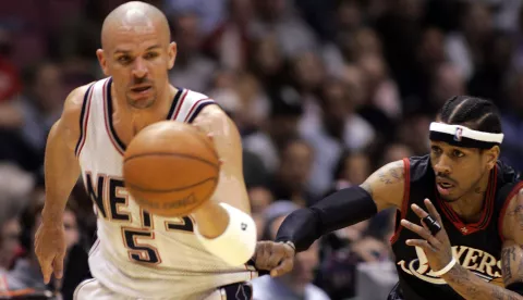 Philadelphia 76ers guard Allen Iverson (R) pulls at the jersey of New Jersey Nets guard Jason Kidd (5) after he stole the ball and broke away in the first period of their NBA game in East Rutherford, New Jersey, April 17, 2005.  REUTERS/Ray Stubblebine