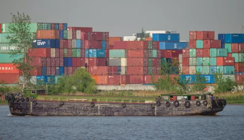 epa12038812 A cargo ship carrying containers and raw materials sails close to Shanghai Container Terminal, in Shanghai, China, 18 April 2025. China announced 125 percent tariffs on US goods effective 12 April, raising its previous rate of 84 percent, in response to the latest US tariffs, which effectively total 145 percent. EPA/ALEX PLAVEVSKI