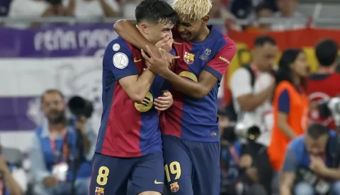 epa12057394 FC Barcelona's Pedri (L) celebrates scoring the 1-0 goal with teammate Lamine Yamal who assisted him during the Spanish King's Cup final soccer match between FC Barcelona and Real Madrid, in Seville, Spain, 26 April 2025. EPA/JULIO MUNOZ