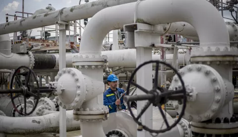 epa10122970 An employee checks control wheel on pipelines at the Central oil tank farm operated by Mero CR near Nelahozeves, Czech Republic, 15 August 2022. Mero CR owns and operates the Czech part of the Druzhba pipeline and the IKL pipeline, is the sole transporter of crude oil to the Czech Republic, and also provides storage for the Czech emergency strategic oil reserves. Both pipelines enter the Central oil tank farm near Nelahozeves, where the company has built a total of 17 oil tanks with a total storage capacity of 1 675 000 m3. In June 2022, the European Union approved a sixth package of sanctions over Russia's invasion of Ukraine, which includes a ban on most Russian oil imports from the turn of the year. Oil transport via the Druzhba pipeline supplying the Czech Republic, Slovakia and Hungary will be temporarily excluded from the embargo. EPA/MARTIN DIVISEK