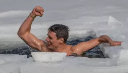 epa09031182 Czech freediver David Vencl reacts after setting a new world record for the longest swim under ice at Lake Vapenka, near Teplice, Czech Republic, 23 February 2021. Vencl, a Teplice freediver and winter swimmer, swam a distance of 80.9 meters under the ice of 30 centimeters thickness in one breath and without a wetsuit shortly after noon on 23 February to set a new Guinness World Record. EPA/MARTIN DIVISEK