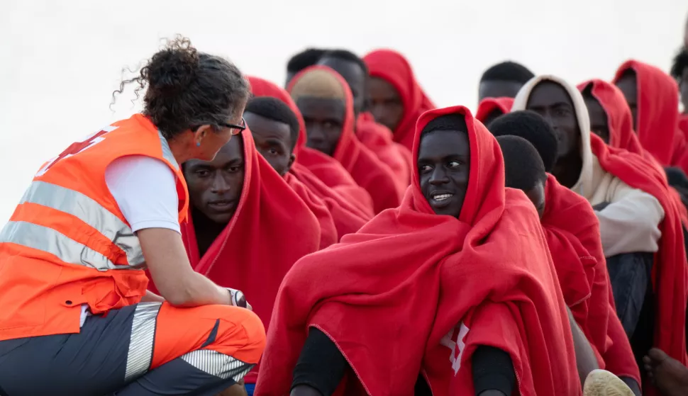 epa12030642 Migrants that were rescued are seen after they were taken to Puerto del Rosario (Fuerteventura), in the Canary Islands, Spain, 13 April 2025, where they were treated by Red Cross personnel. The Maritime Rescue vessel Guardamar Talia rescued a group of 50 people, 45 men, four women, and a minor who called for help from the inflatable boat on which they were trying to reach the Canary Islands. EPA/Carlos de Saa