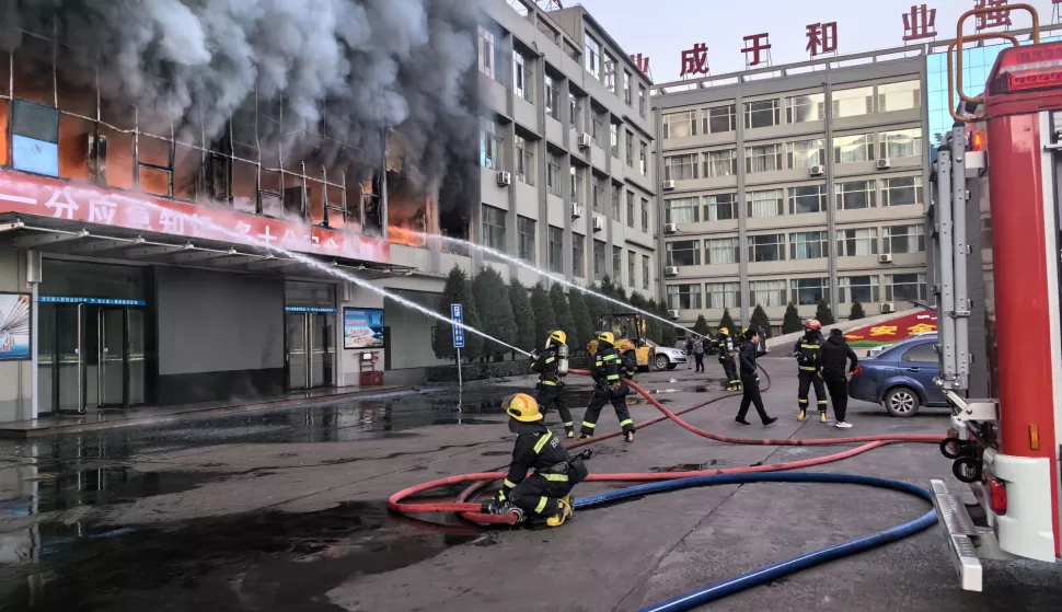epa10977883 Firefighters try to put out a fire at a building of a coal mine company in Lyuliang City, north China's Shanxi Province, 16 November 2023. The death toll has risen to 26 after a fire broke out on 16 November morning at a building of a coal mine company in north China's Shanxi Province, according to rescuers. The fire ripped through the second floor of the five-story building located in Lishi District of Lyuliang City. Rescue efforts are underway, according to local authorities. More than 60 people have been sent to a local hospital for treatment. The building belongs to the private Yongju coal mine company. EPA/XINHUA/ZHAN YAN CHINA OUT/UK AND IRELAND OUT/  MANDATORY CREDIT EDITORIAL USE ONLY EDITORIAL USE ONLY