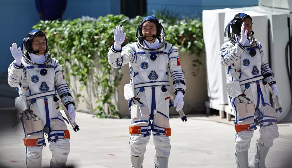 epa12050727 Shenzhou-20 space mission astronauts Chen Zhongrui (R), Chen Dong (C) and Wang Jie, greet members of the public during the seeing-off ceremony at the Jiuquan Satellite Launch Center near Jiuquan, China, 24 April 2025. EPA/ANDRES MARTINEZ CASARES