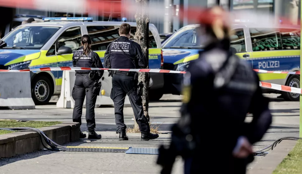 epa11938009 Police officers stand guard near the scene after a vehicle was driven into pedestrians in Mannheim, Germany, 03 March 2025. According to statements from police, a vehicle drove into a crowd in the Mannheim city centre, killing one person and injuring several others. EPA/RONALD WITTEK