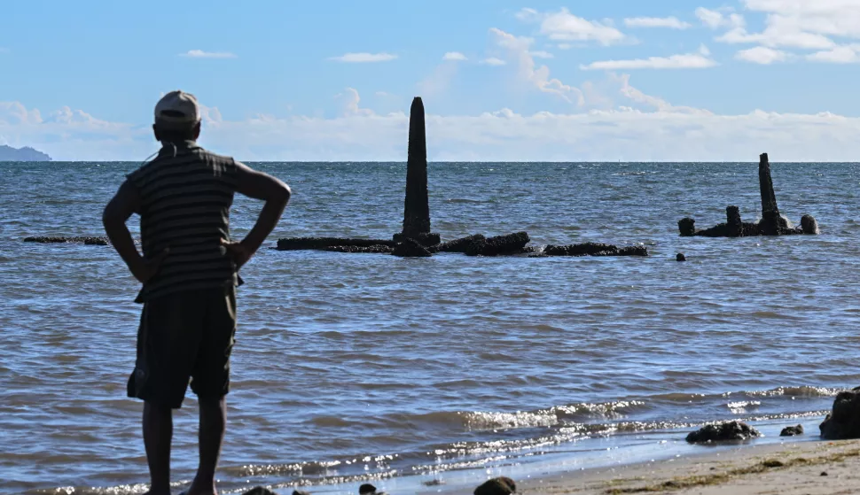 epa10362818 A local villager looks at the gravestone of his grandfather, which has been impacted by rising sea levels during the Fijian election campaign in the village of Togoru, Fiji, 13 December 2022. General elections will be held in Fiji on 14 December 2022. Climate change imapact and rising sea levels is one of the key issues in this election. EPA/MICK TSIKAS AUSTRALIA AND NEW ZEALAND OUT