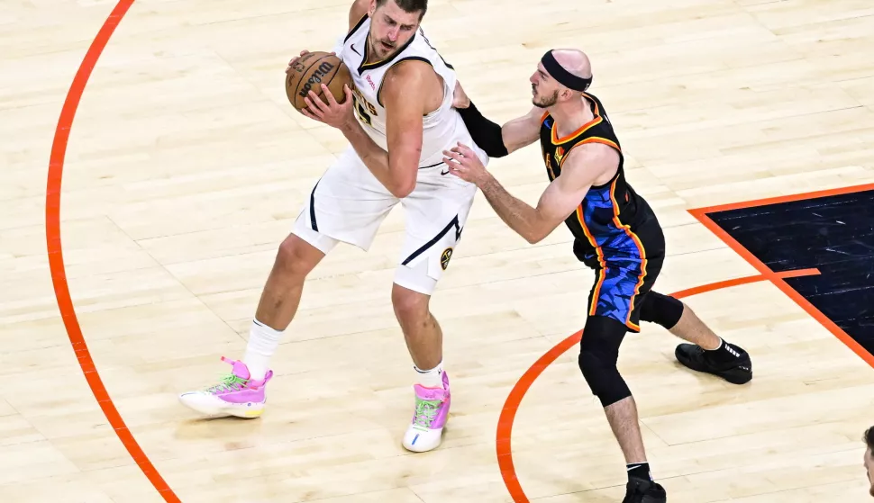 epa12076940 Denver Nuggets center Nikola Jokic drives against Oklahoma City Thunder guard Alex Caruso during the second half of the Western Conference Semifinals game one between the Oklahoma City Thunder and the Denver Nuggets in Oklahoma City, Oklahoma, USA, 05 May 2025. EPA/GERALD LEONG SHUTTERSTOCK OUT