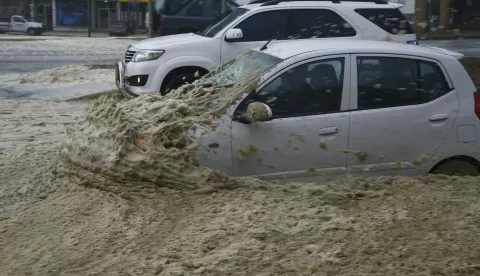 epa06015403 Vehicles move along a flooded road on Seapoint promenade during a storm in Cape Town, South Africa 07 June 2017. A powerful storm with gale force winds, heavy rain and seas in excess of 10 meters lashed the peninsula causing damage to property and vegetation in what is being reported the biggest storm in Cape Town in 30 years. EPA/NIC BOTHMA