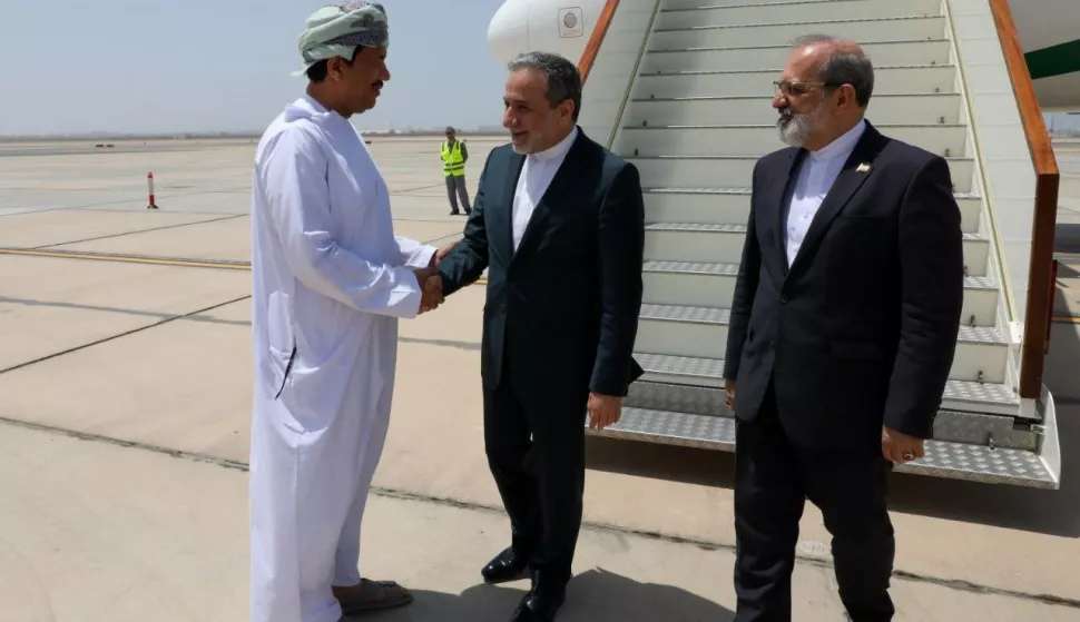 epa12090452 A handout photo made available by the Iranian Foreign Ministry shows Iranian Foreign Minister Abbas Araghchi (C) greeting an Omani official upon arrival at the airport in Muscat, Oman, 11 May 2025. Iran and the US hold their fourth round of nuclear talks in Muscat on the same day. EPA/IRANIAN FOREIGN MINISTRY HANDOUT EDITORIAL USE ONLY/NO SALES