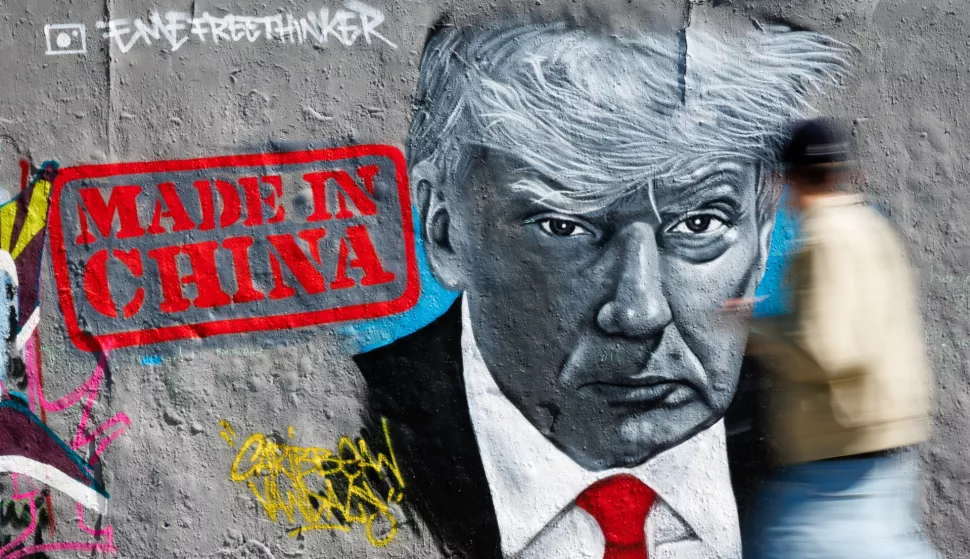 epaselect epa12060350 A passer-by walks in front of a graffito of Berlin-based artist Eme Freethinker that shows US President Donald J. Trump next to the writing 'Made in China' at the Mauerpark in Berlin, Germany, 28 April 2025. The United States of America and China are in a fight about tariff policies. EPA/CLEMENS BILAN