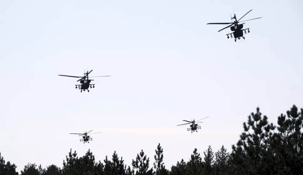 epa12069452 US Army's AH-64D Apache attack helicopters conduct aerial gunnery training at Adazi Military training ground in Latvia, 02 May 2025. During the training, the final stage of the regular certification process also took place which will certify that Apache helicopter crews are capable of conducting combat operations, firing and neutralizing various types of targets Ð stationary and moving. EPA/VALDA KALNINA