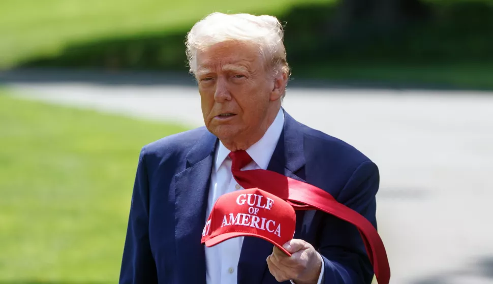 epa12063428 US President Donald Trump walks holding a 'Gulf of America' baseball cap on the South Lawn of the White House before departing to Michigan, in Washington, DC, USA, 29 April 2025. President Trump is due to host a rally in Michigan to mark 100 days since the start of his second term. EPA/WILL OLIVER