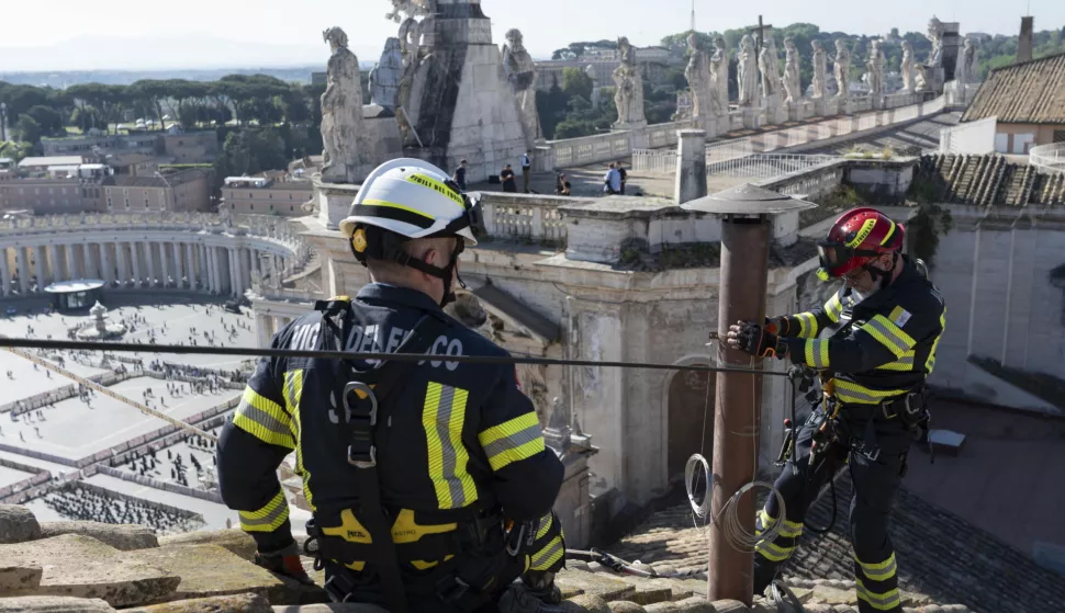 epa12070593 A handout picture provided by the Vatican Media shows firefighters installing the chimney atop the Sistine Chapel ahead of the Conclave, in Vatican City, 02 May 2025 (issued 03 May 2025). The Conclave to elect the successor of late Pope Francis will be held on 07 May. EPA/VATICAN MEDIA HANDOUT HANDOUT EDITORIAL USE ONLY/NO SALES