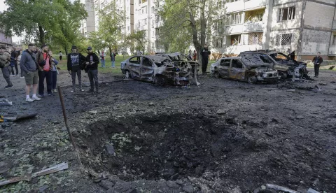 epa12072633 Locals look at a shelling hole at the site of an overnight drone strike that hit a residential area in Kyiv, Ukraine, 04 May 2025, amid the ongoing Russian invasion. At least eleven people were injured, including two children, in the strike on the residential area, according to the State Emergency Service report. Russia launched a large-scale overnight attack using 165 drones across all of Ukraine, according to the Air Force Command of Ukraine. EPA/SERGEY DOLZHENKO
