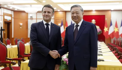 epa12136149 Vietnamese General Secretary of the Communist Party To Lam (R) shakes hands with French President Emmanuel Macron (L) at the Office of the Party Central Committee in Hanoi, Vietnam, 26 May 2025. Macron is on a state visit to Vietnam from 25 to 27 May 2025. EPA/LUONG THAI LINH/POOL