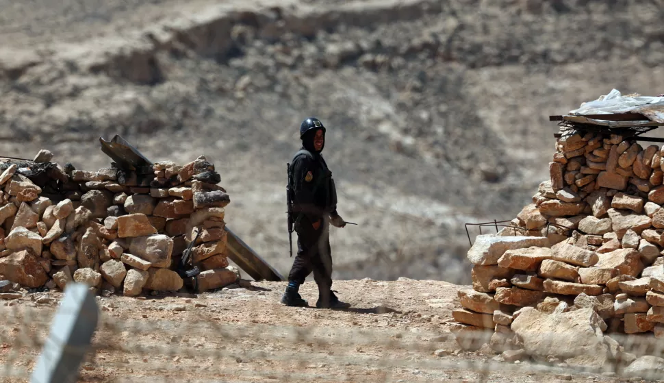 epa12035255 An Egyptian soldier patrols on the Egyptian side of the border as seen from Israel across the fence that runs along the Israeli-Egyptian border in the south of Israel, 16 April 2025. The location normally closed to tourists is partially open during the Passover holiday. The border runs approximately 246 kilometers, from Rafah in the Gaza Strip to Eilat on the Red Sea. EPA/ATEF SAFADI