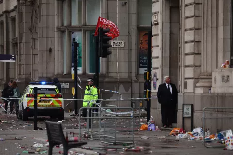 epa12137422 A police officer on the scene where a car collided with Liverpool supporters during the trophy parade in Liverpool city centre, Britain, 26 May 2025. A man has been detained after the collision with a number of pedestrians during Liverpool FC's victory parade, Merseyside Police said. EPA/ADAM VAUGHAN