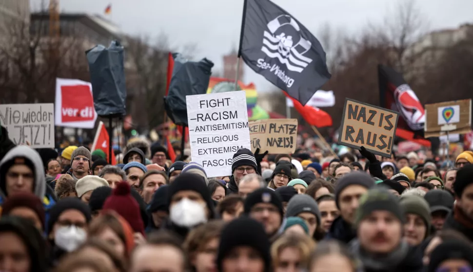 epa11076157 People carry placards and banners as they gather during a demonstration against the far-right Alternative for Germany (AfD) party in front of the Brandenburg Gate in Berlin, Germany, 14 January 2024. The protest held under the slogan 'Defend Democracy', was organized by the Fridays for Future movement, along with other non-governmental organizations, as a reaction to revelations of the investigative journalism group Correctiv, and their report about a meeting of far-right politicians, who allegedly discussed deportation plans referred to as 'remigration', a term promoting the forced return of 'migrants' to their place of origin. EPA/CLEMENS BILAN