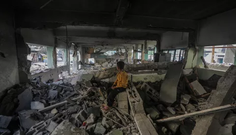 epa12136568 An internally displaced Palestinian boy sits at the destroyed building of Al Jerjawi school following Israeli airstrike in Al Daraj neighborhood in Gaza City on 26 May 2025. According to the Palestinian Health Ministry in Gaza over 30 Palestinians were killed in the airstrike in the early hours of the morning. More than 53,900 Palestinians have been killed in the Gaza Strip, according to the Palestinian Ministry of Health, since Israel launched a military campaign in the strip in response to a cross-border attack led by the Palestinian militant group Hamas on 07 October 2023, in which about 1,200 Israelis were killed and more than 250 taken hostage. EPA/MOHAMMED SABER