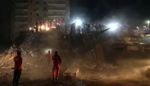 epa08791597 Rescue workers search for survivors at the site of a collapsed building after a 7.0 magnitude earthquake in the Aegean Sea, at Bayrakli district in the Aegean Sea, at Bayrakli district in Izmir, Turkey, 01 November 2020. According to Turkish media reports, at least 62 have people died while more than 800 were injured and dozens of buildings were destroyed in the earthquake. EPA/ERDEM SAHIN