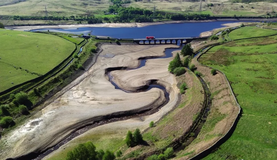 epa12095831 An aerial photograph taken with a drone shows the partially revealed bed of Woodhead Reservoir in Derbyshire, Britain, 13 May 2025. The UK Environment Agency has warned of the risk of a summer drought, as England has experienced the driest start to spring since 1956 due to below average rainfall and the sunniest April on record. EPA/ADAM VAUGHAN