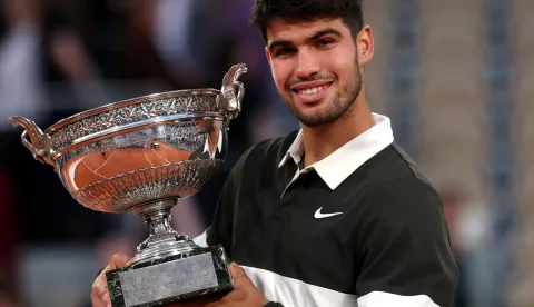 epa12164662 Carlos Alcaraz of Spain celebrates with the Coupe des Mousquetaires after winning his Men's final match against Jannik Sinner of Italy at the French Open Grand Slam tennis tournament at Roland Garros in Paris, France, 08 June 2025. EPA/MOHAMMED BADRA