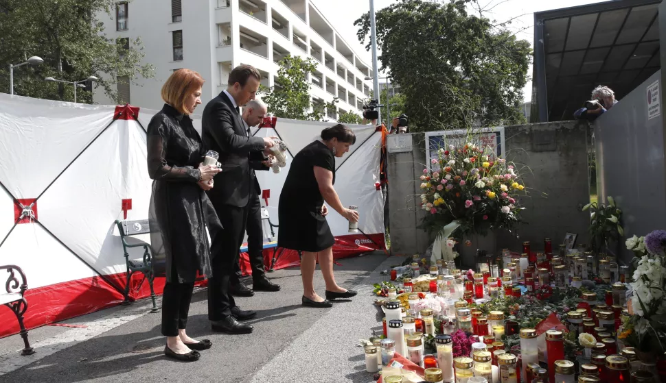 epa12169621 Vice Governor of Styria Willbald Ehenhoefer Manuela Khom (R) pays tribute to the victims of the school shooting in Graz, Austria, 11 June 2025. At least nine people were killed in the incident on 10 June, including the shooter, authorities confirmed. EPA/ANTONIO BAT