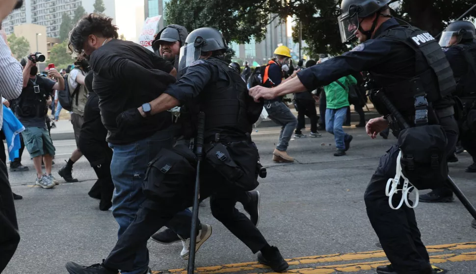 epa12167307 Police detain a protester as they clash in Los Angeles, California, USA, 09 June 2025. Approximately 2,000 National Guard troops were deployed on 08 June in Los Angeles by US President Donald Trump, though the state of California had not requested any additional assistance, and protests have continued against the Trump administration's immigration enforcement raids over the last couple of days. EPA/ALLISON DINNER