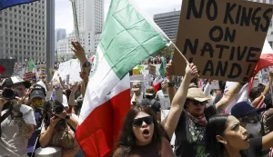 epa12175838 A person carries a Mexican flag during a 'No Kings' protest in Los Angeles, California, USA, 14 June 2025. 'No Kings' protests are expected to be held all over the country to protest President Donald Trump and his administration's policies. EPA/CAROLINE BREHMAN