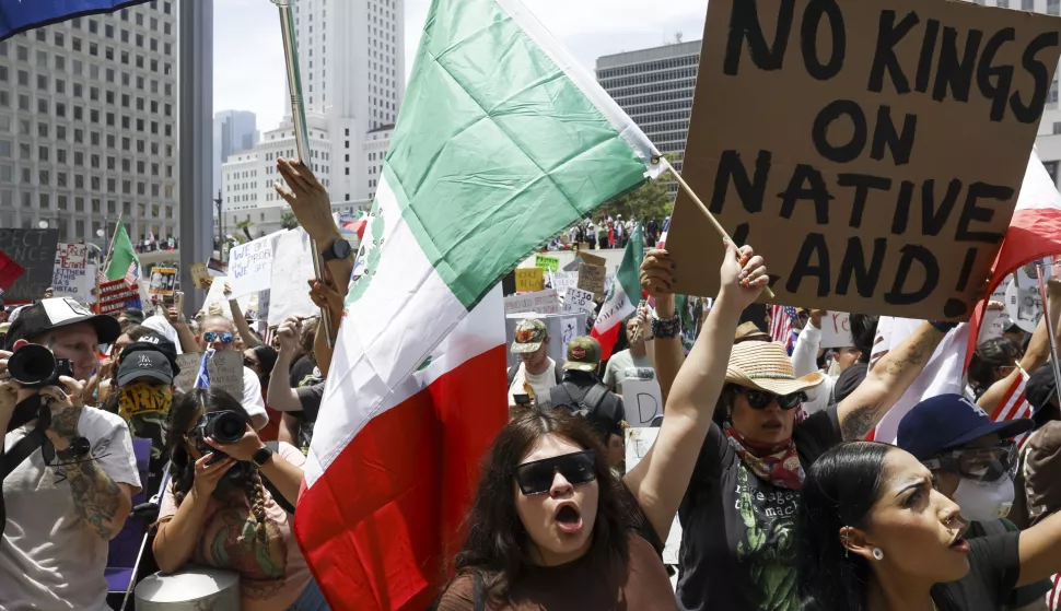 epa12175838 A person carries a Mexican flag during a 'No Kings' protest in Los Angeles, California, USA, 14 June 2025. 'No Kings' protests are expected to be held all over the country to protest President Donald Trump and his administration's policies. EPA/CAROLINE BREHMAN