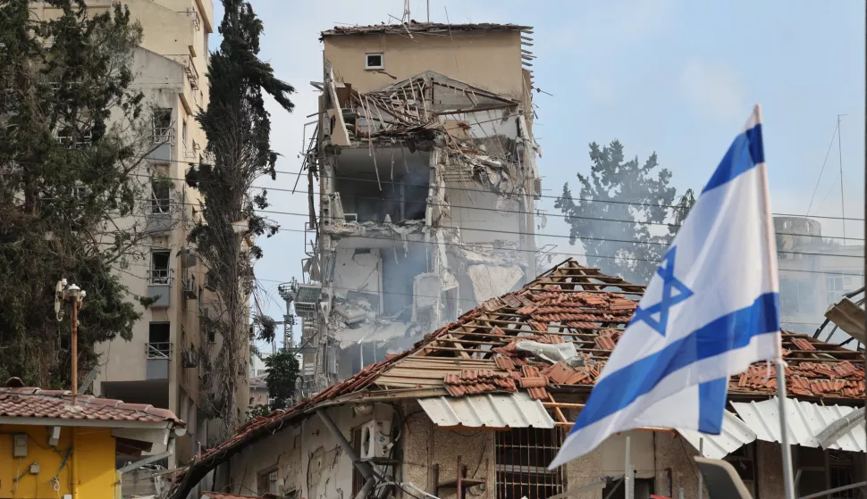 epa12176678 Israeli rescue teams work at the site of a damaged residential area after Iranian ballistic missiles hit Rehovot, central Israel, 15 June 2025. Iran launched a barrage of ballistic missiles at Israel overnight in retaliation for Israeli airstrikes on Iranian targets. Magen David Adom (MDA), Israel's national emergency services, reported at least six killed and dozens injured, including two in critical condition. EPA/ABIR SULTAN