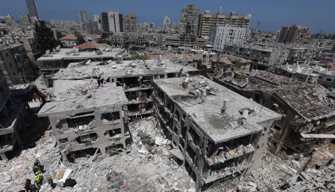 epa12176800 Members of Israel's Home Front Command search for missing people under the rubble of a partially collapsed residential building after Iranian ballistic missiles hit Bat Yam, central Israel, 15 June 2025. Iran launched a barrage of ballistic missiles at Israel overnight in retaliation for Israeli airstrikes on Iranian targets. Magen David Adom (MDA), Israel's national emergency services, reported at least six killed and dozens injured, including two in critical condition. EPA/ABIR SULTAN