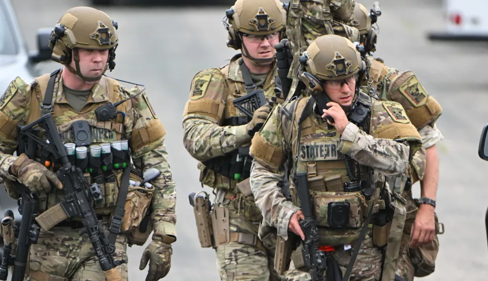 epa12177806 Authorities gather at a baseball park in Green Isle, Minnesota, USA, 15 June 2025, as they search for the 57-year-old Vance Luther Boelter, the suspect in the fatal shooting of Minnesota State Representative Melissa Hortman and her husband, Mark, in their Brooklyn Park home on 14 June and a separate shooting attack on Democratic State Senator John Hoffman and his wife, Yvette, on the same day. EPA/CRAIG LASSIG