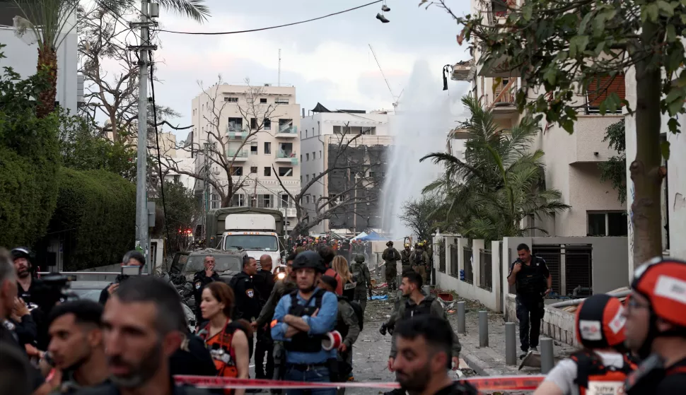 epa12178325 Israeli rescue teams and medical personnel gather at the scene where Iranian ballistic missiles struck buildings in Tel Aviv, Israel, 16 June 2025. According to emergency service, Magen David Adom (MDA), paramedics have pronounced the death of four people and provided medical care to a total of 81 injured, one in serious condition and five in moderate condition. EPA/ATEF SAFADI