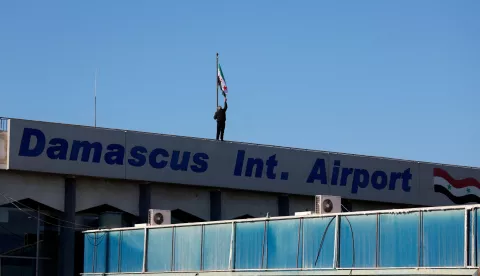 FILE PHOTO: A worker adjusts the flag adopted by the new Syrian rulers on the day the first domestic flight departs from Damascus International Airport to Aleppo International Airport during the re-opening of the airport after the ousting of Syria's Bashar al-Assad, in Damascus, Syria, December, 18 2024. REUTERS/Ammar Awad/File Photo Photo: AMMAR AWAD/REUTERS
