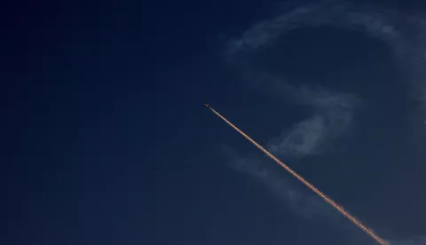 epa12174610 An airplane changes its flight route above Nablus city as Israel's Iron Dome air defense system intercepts projectiles over the West Bank, 14 June 2025. Israel's military said Iran launched dozens of missiles and drones toward Israel, with some intercepted. Magen David Adom (MDA), Israel's national emergency services, reported at least three killed and dozens of injured, including some in critical condition, in the retaliatory attacks. Israel launched strikes on Iran's nuclear and military facilities on 13 June, targeting top generals and scientists. EPA/ALAA BADARNEH