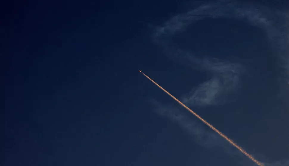 epa12174610 An airplane changes its flight route above Nablus city as Israel's Iron Dome air defense system intercepts projectiles over the West Bank, 14 June 2025. Israel's military said Iran launched dozens of missiles and drones toward Israel, with some intercepted. Magen David Adom (MDA), Israel's national emergency services, reported at least three killed and dozens of injured, including some in critical condition, in the retaliatory attacks. Israel launched strikes on Iran's nuclear and military facilities on 13 June, targeting top generals and scientists. EPA/ALAA BADARNEH