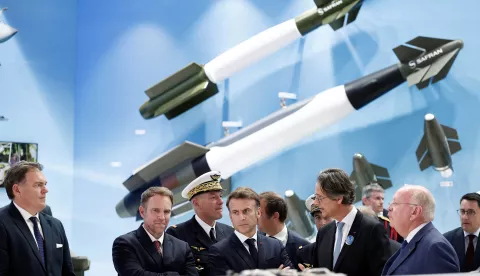 epa12187286 French President Emmanuel Macron (C) listens to CEO of Safran Olivier Andries (2-R) as French Minister for Transport Philippe Tabarot (L), Minister for Industry and Energy Marc Ferracci (2-L), and Ross McInnes (R), Chairman of the Board of Safran, look on at the stand of aerospace and defense company Safran during a visit at the 55th International Paris Air Show at Le Bourget Airport near Paris, France, 20 June 2025. The Paris Air Show, one of the largest trade fairs of the aerospace industry and air shows in the world, runs from 16 to 22 June. EPA/BENOIT TESSIER/POOL MAXPPP OUT