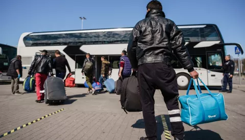 epa08352652 Seasonal harvest workers, who arrived with a charter flight from Romania, walk towards a bus, after the arrival at the Berlin-Schoenefeld airport in Schoenefeld, Germany, 09 April 2020. Due to the ongoing pandemic of the COVID-19 disease caused by the SARS-CoV-2 coronavirus and resulting closed boarders, a lack of harvest helpers appeared. Aircraft carrier Eurowings brings foreign workers to Germany, to support farmers in during the harvest of asparagus and strawberries. EPA/CLEMENS BILAN