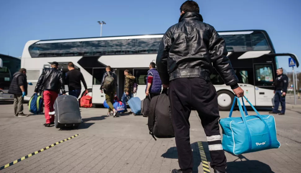 epa08352652 Seasonal harvest workers, who arrived with a charter flight from Romania, walk towards a bus, after the arrival at the Berlin-Schoenefeld airport in Schoenefeld, Germany, 09 April 2020. Due to the ongoing pandemic of the COVID-19 disease caused by the SARS-CoV-2 coronavirus and resulting closed boarders, a lack of harvest helpers appeared. Aircraft carrier Eurowings brings foreign workers to Germany, to support farmers in during the harvest of asparagus and strawberries. EPA/CLEMENS BILAN