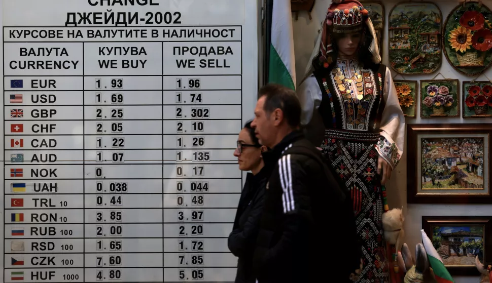 epa12064416 People walk past a board with currency rates at an exchange office in Sofia, Bulgaria, 30 April 2025. Bulgaria's current currency is the Bulgarian Lev (BGN), which has been in use since 1880. The country aims to adopt the Euro on 01 January 2026. The European Commission has set the date for the publication of the extraordinary convergence report on Bulgaria's readiness to adopt the Euro for 04 June 2025. EPA/VASSIL DONEV