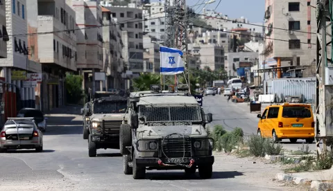 epa12183457 Israeli army vehicles move in the streets during a military operation in the Balata refugee camp, near the West Bank city of Nablus, 18 June 2025. According to the Palestinian Health Ministry, at least 20 Palestinians were wounded during the operation. EPA/ALAA BADARNEH