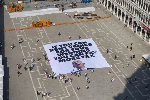 epa12192418 A handout photo made available by Greenpeace press office shows activists of the environmental group Greenpeace unfolding a giant banner with the image of US businessman and Amazon founder Jeff Bezos, and a slogan reading 'If you can rent Venice for your wedding you can pay more tax' at St Mark's Square in Venice, Italy, 23 June 2025. Venice will host the wedding of Jeff Bezos and his fiancee journalist Lauren Sanchez in June 2025. EPA/GREENPEACE PRESS OFFICE HANDOUT HANDOUT EDITORIAL USE ONLY/NO SALES